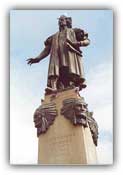 A statue of Christopher Columbus stands atop Native American chiefs in Syracuse, NY. The inscription reads: 'Cristoforo Colombo/Discoverer of America'
