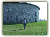 Teddy in front of a Shaker barn